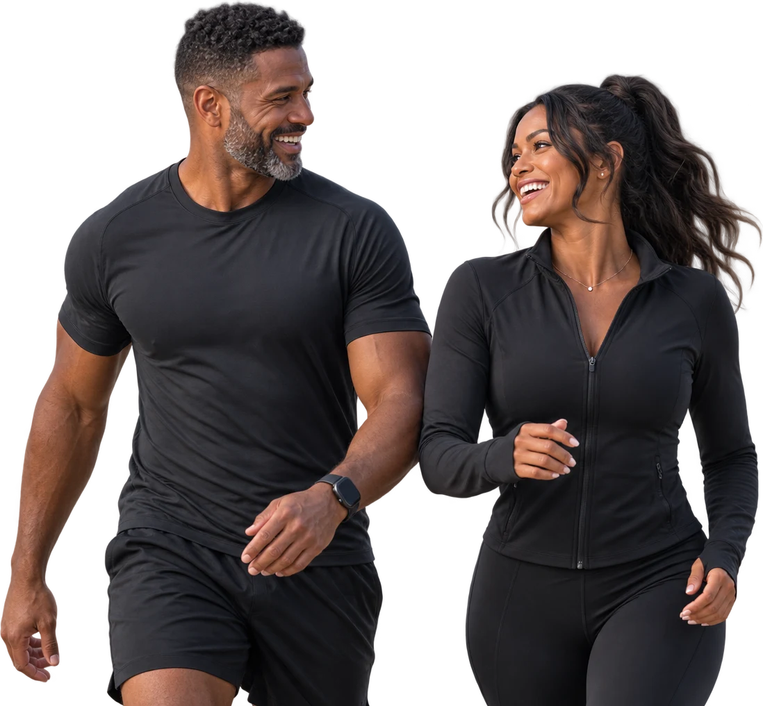 A man and a woman in dark athletic clothing walking together and laughing